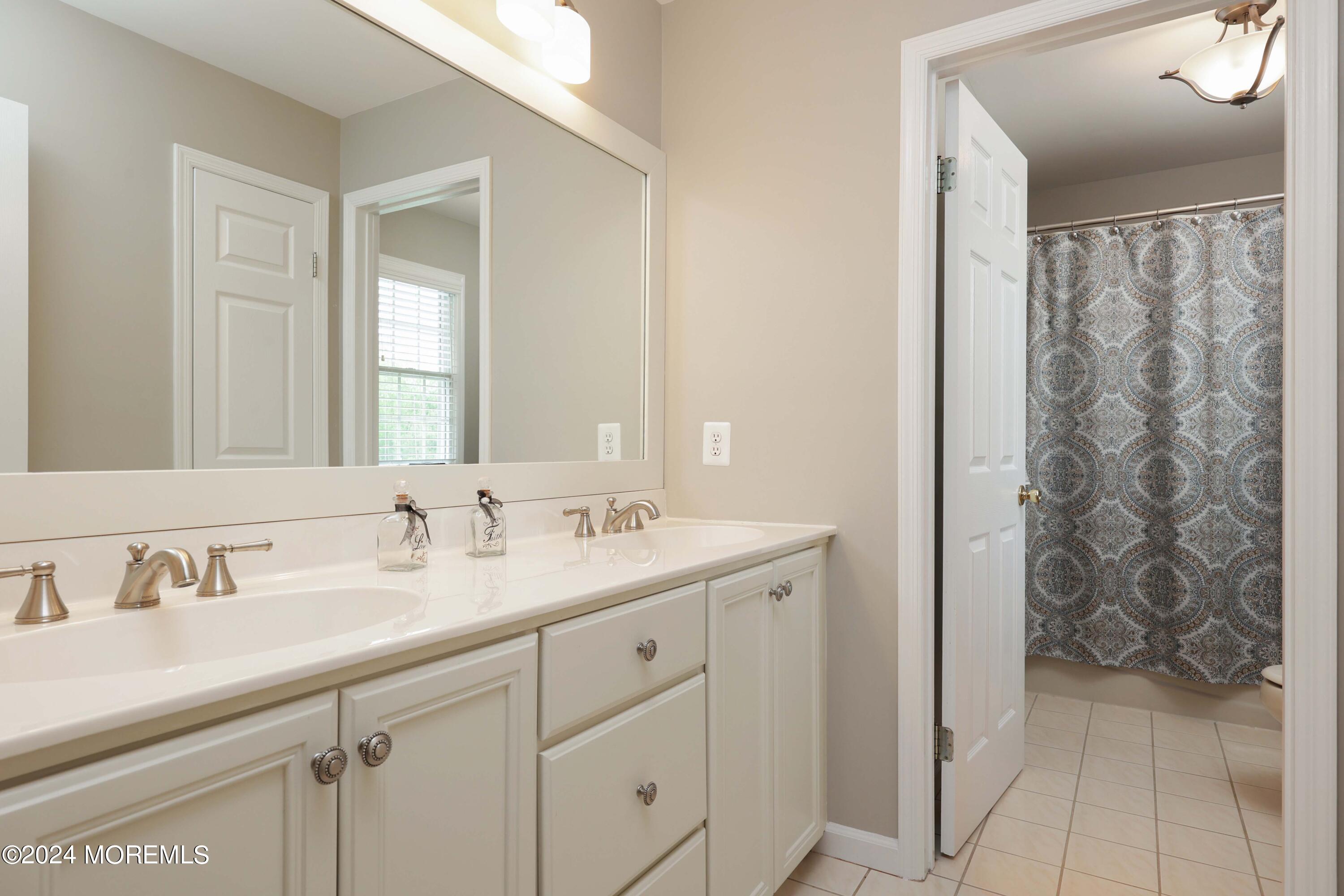 12 Shadowbrook Drive Colts Neck, NJ 07722 - Photo 20 of 33 a bathroom with a granite countertop sink and a mirror