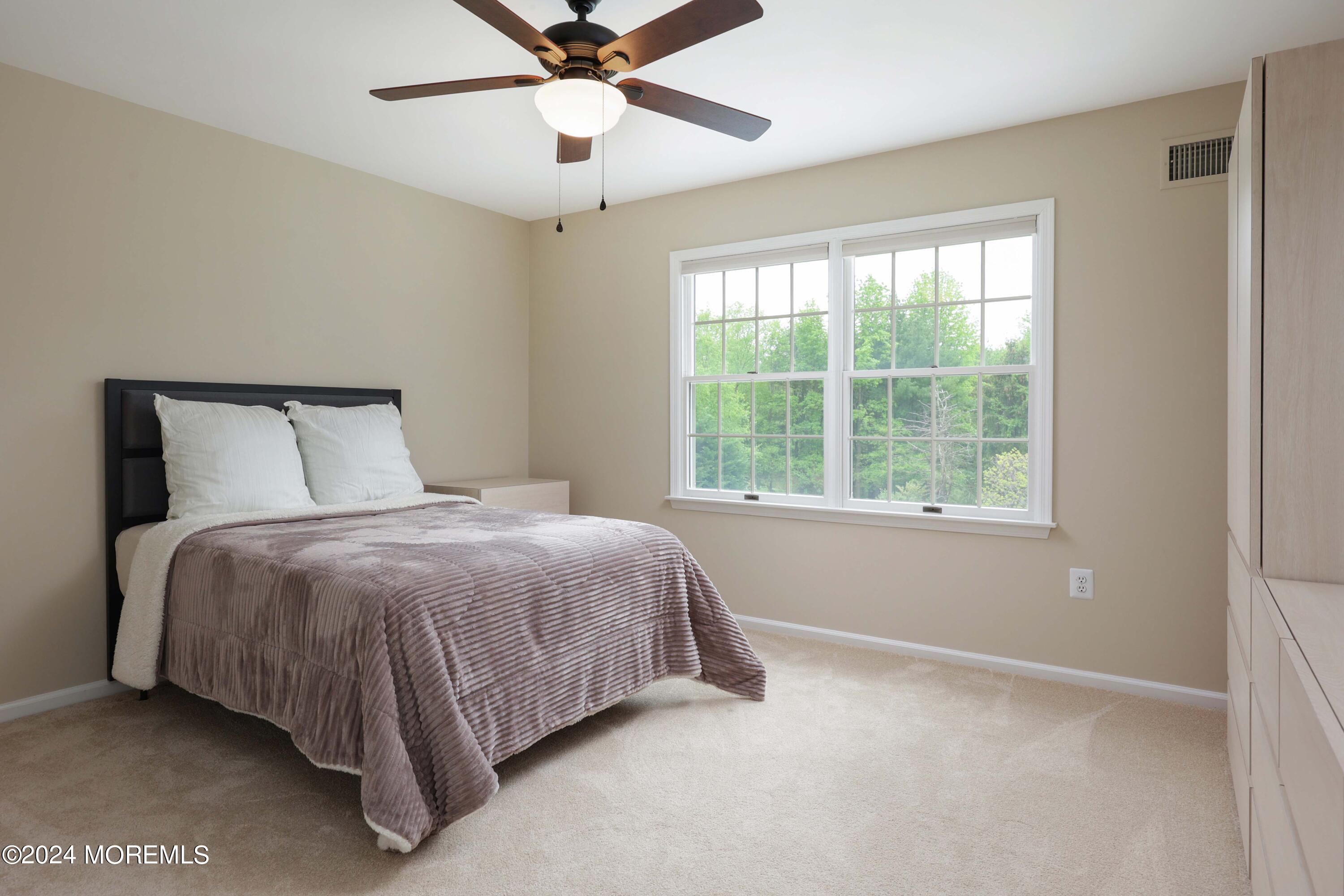 12 Shadowbrook Drive Colts Neck, NJ 07722 - Photo 21 of 33 a bedroom with a bed and window