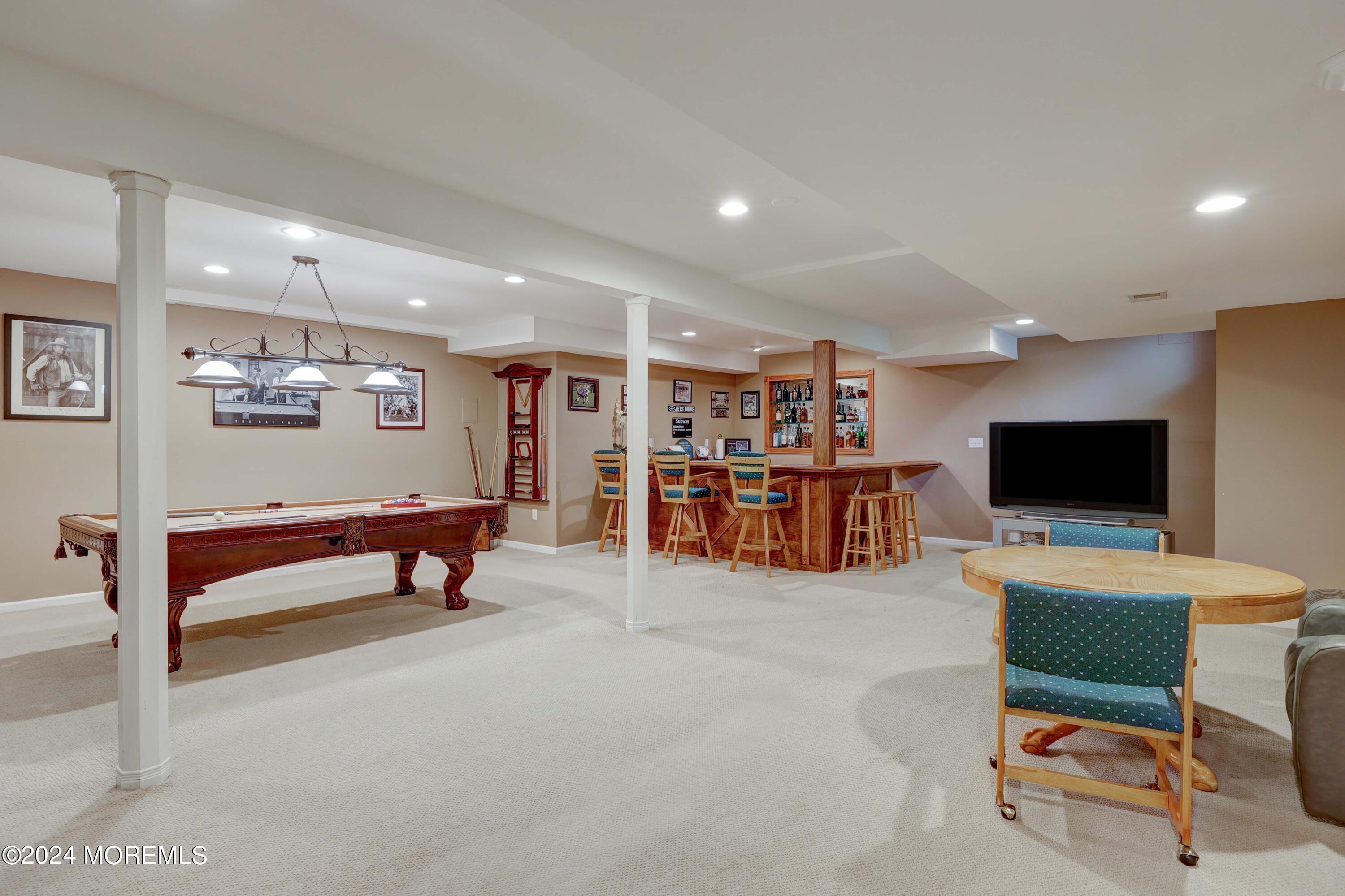 12 Shadowbrook Drive Colts Neck, NJ 07722 - Photo 22 of 33 a living room with furniture and a flat screen tv