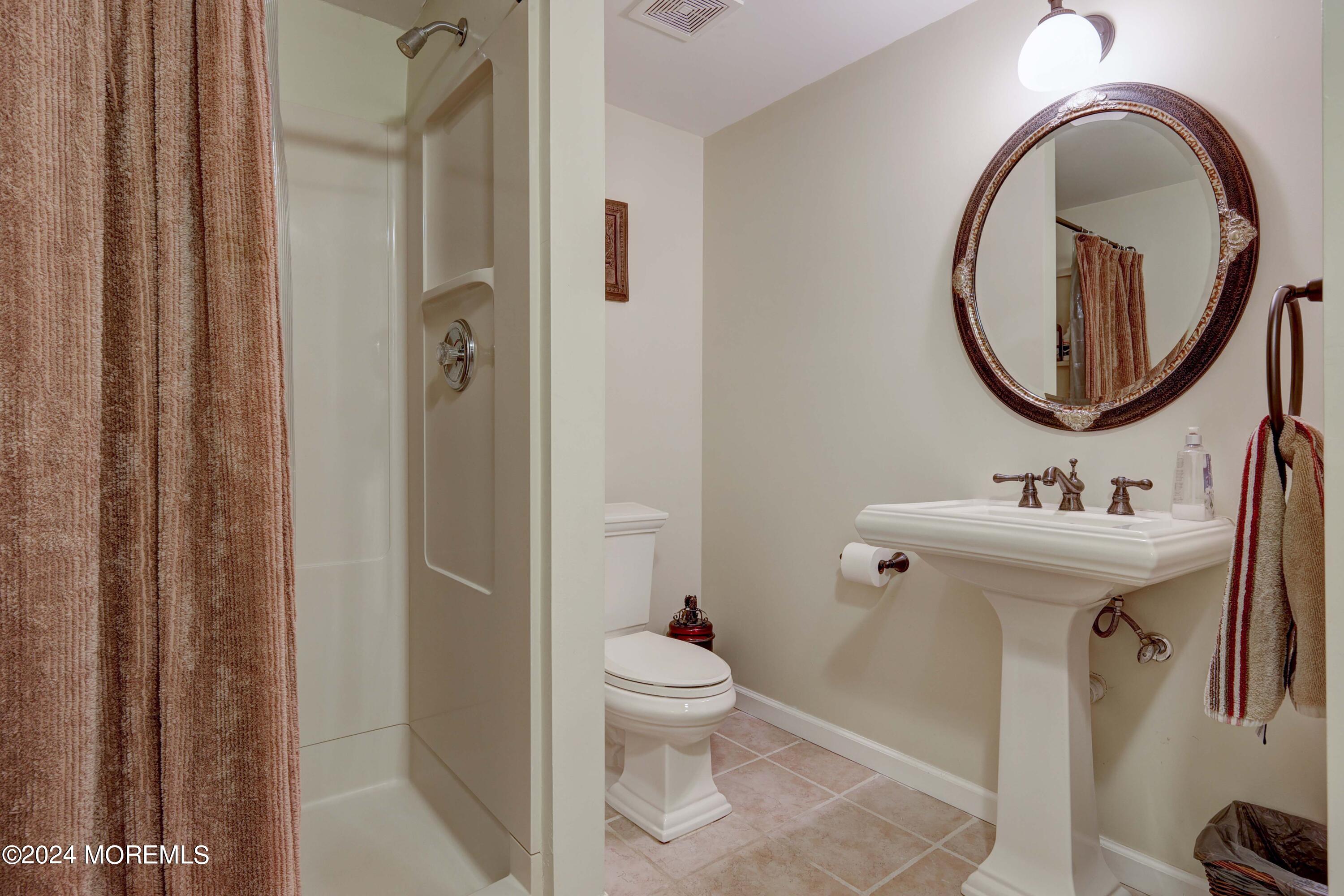 12 Shadowbrook Drive Colts Neck, NJ 07722 - Photo 23 of 33 a bathroom with a sink a toilet and a mirror