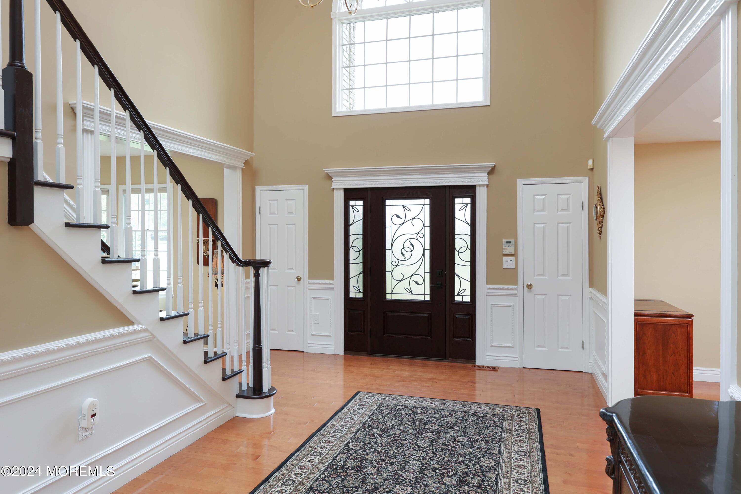 12 Shadowbrook Drive Colts Neck, NJ 07722 - Photo 4 of 33 a view of an entryway with wooden floor and a rug