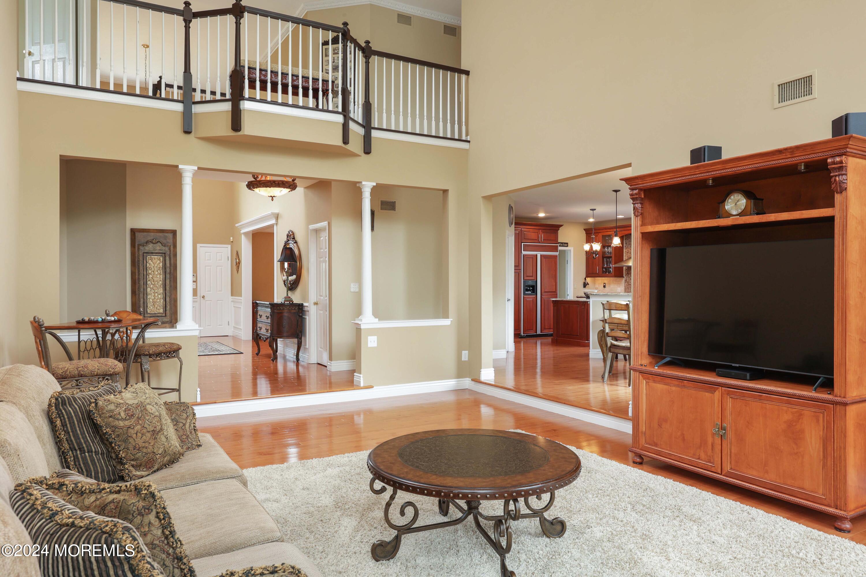 12 Shadowbrook Drive Colts Neck, NJ 07722 - Photo 7 of 33 a living room with furniture a flat screen tv and kitchen view