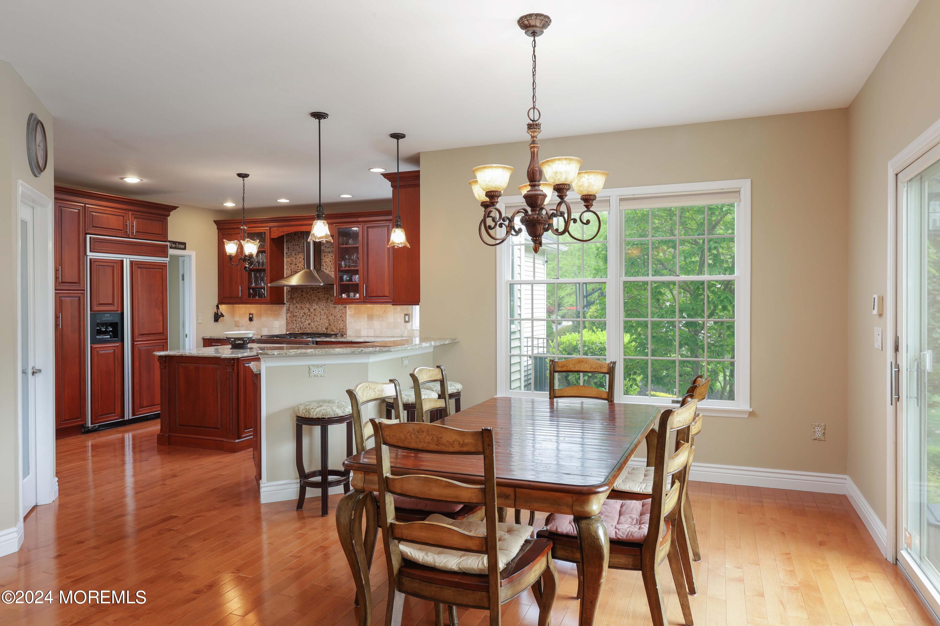 12 Shadowbrook Drive Colts Neck, NJ 07722 - Photo 8 of 33 a view of a dining room with furniture window and wooden floor
