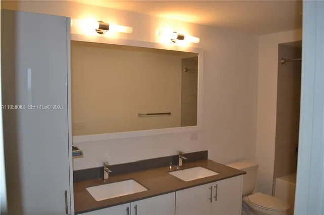 a bathroom with a tub a sink and a toilet