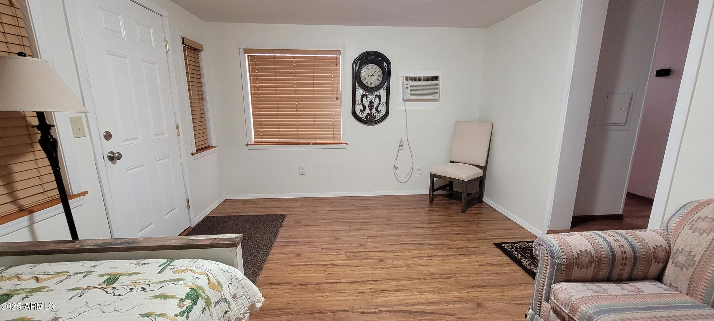 30850 South Vagabond Trail, Unit 87 Congress, AZ 85332 - Photo 11 of 19 a view of a bedroom with wooden floor and a window