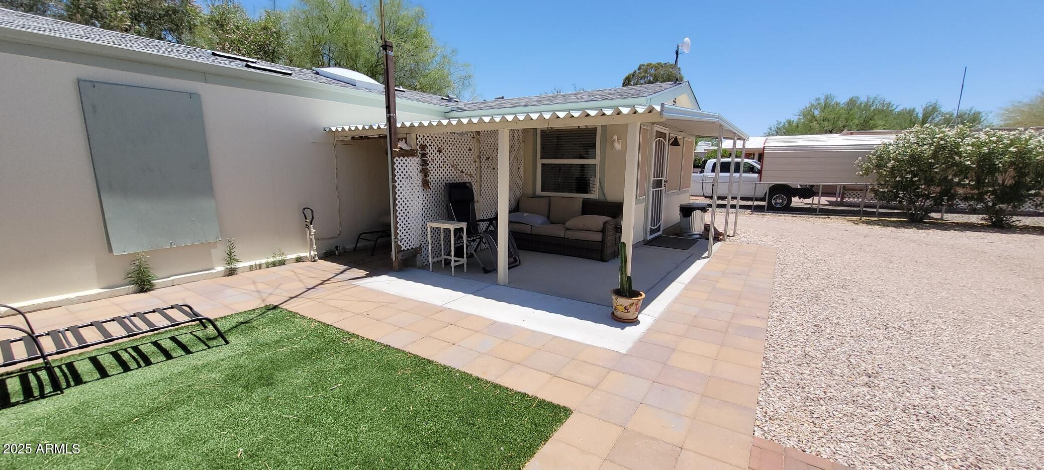 30850 South Vagabond Trail, Unit 87 Congress, AZ 85332 - Photo 15 of 19 a view of a patio with table and chairs near a yard