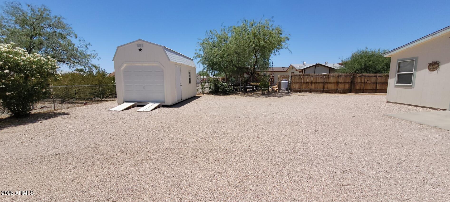 30850 South Vagabond Trail, Unit 87 Congress, AZ 85332 - Photo 18 of 19 a front view of a house with a yard and garage