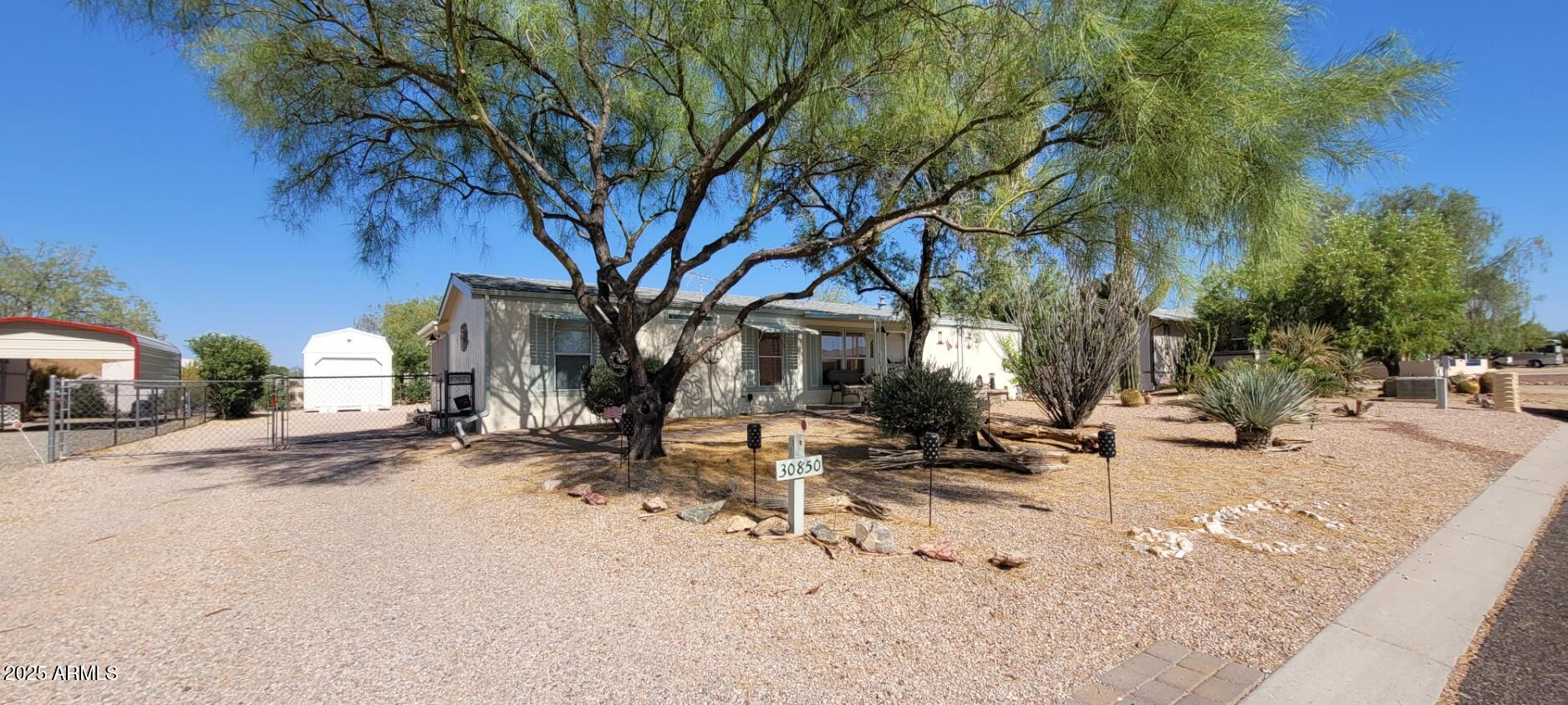 30850 South Vagabond Trail, Unit 87 Congress, AZ 85332 - Photo 2 of 19 a view of a backyard with a tree
