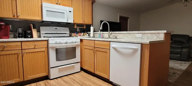 a kitchen with cabinets appliances and a sink