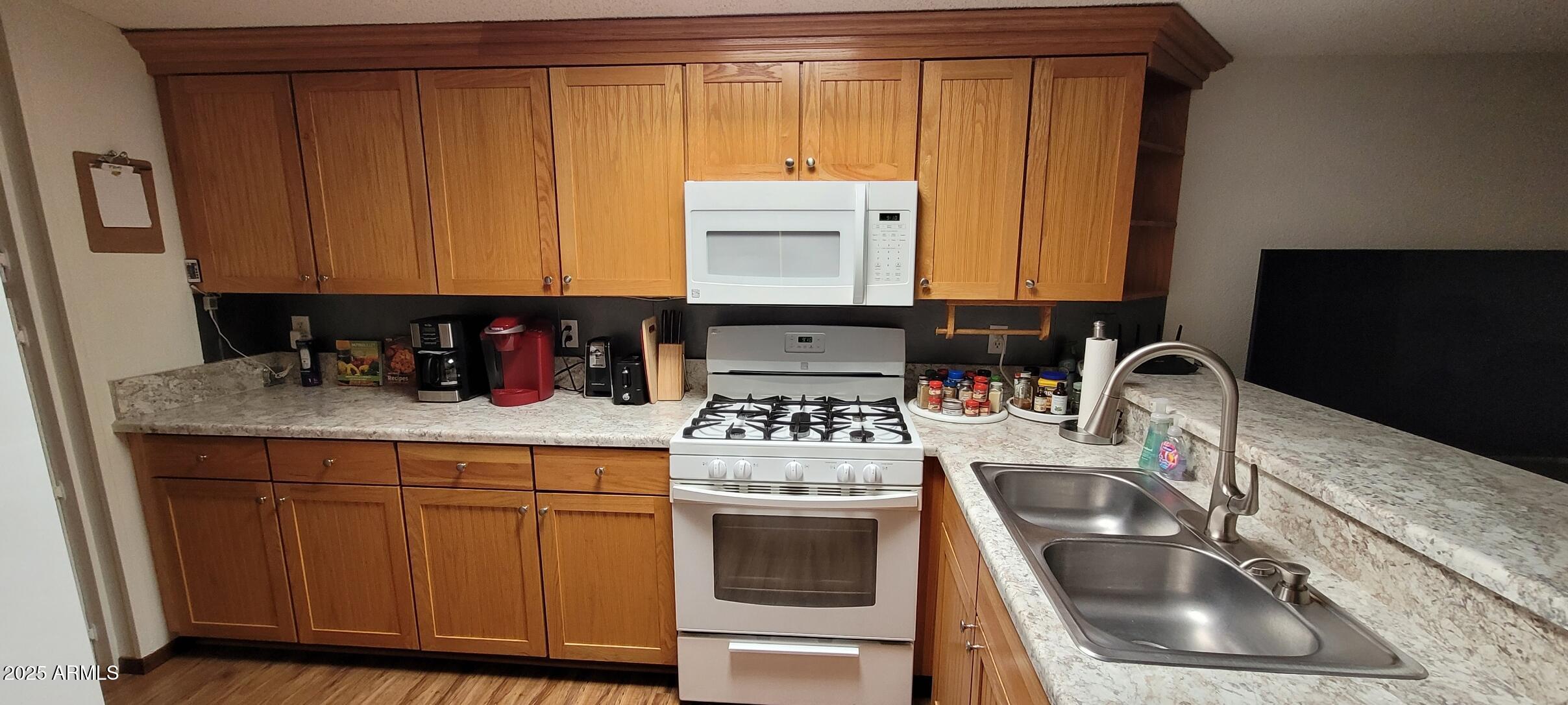 30850 South Vagabond Trail, Unit 87 Congress, AZ 85332 - Photo 5 of 19 a kitchen with a sink stove and cabinets