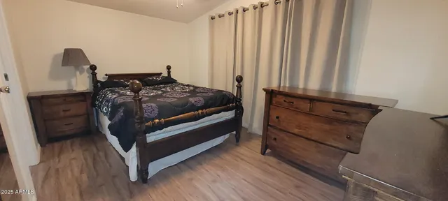a bedroom with a bed and a mirror