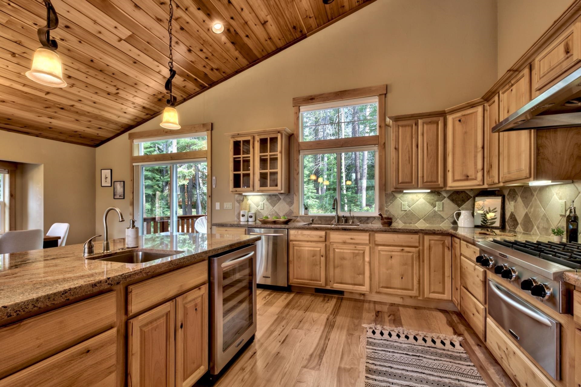 14121 Swiss Lane Truckee, CA 96161 - Photo 11 of 21 a large kitchen with stainless steel appliances granite countertop a sink and wooden cabinets
