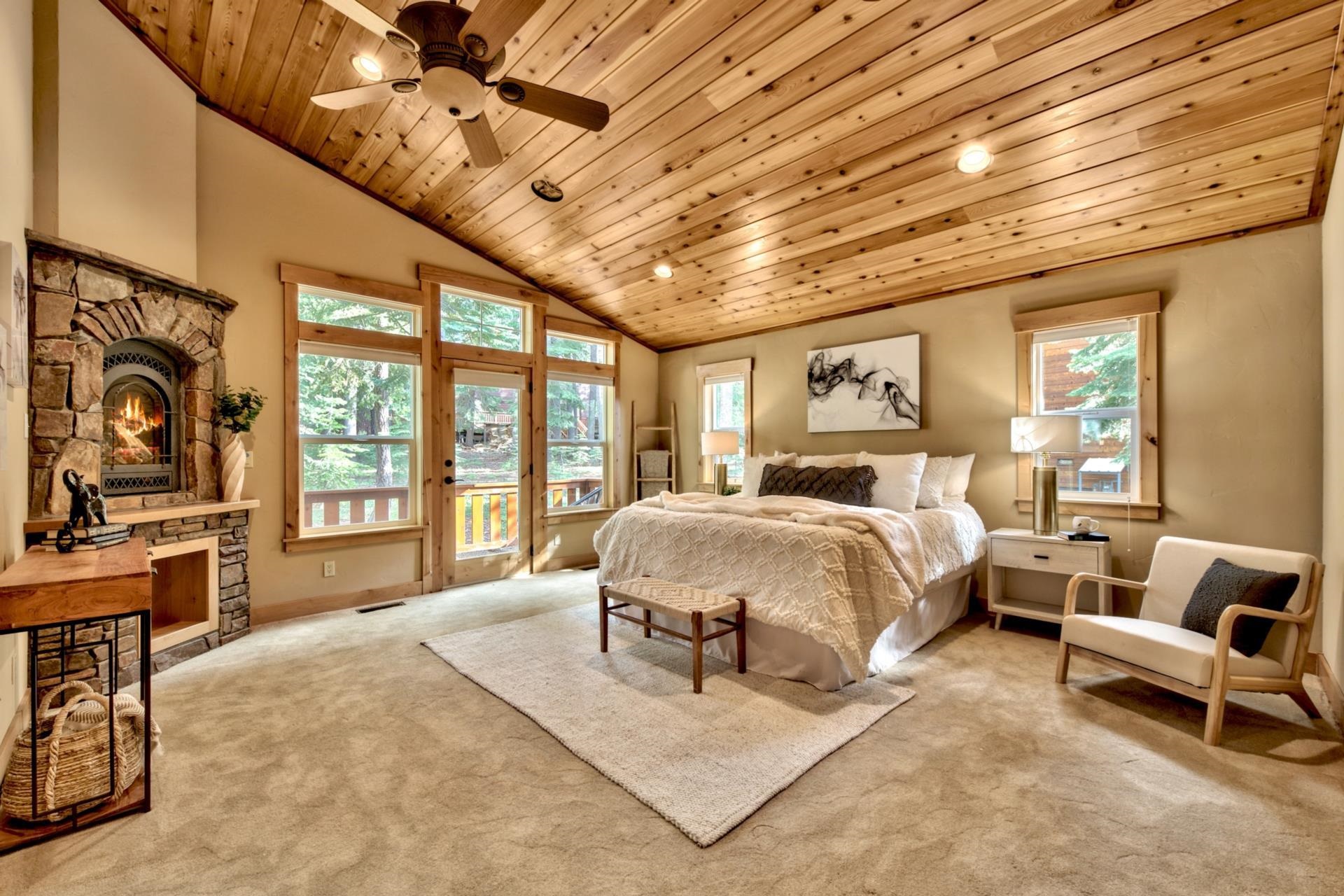 14121 Swiss Lane Truckee, CA 96161 - Photo 14 of 21 a spacious bedroom with a large bed and a chandelier