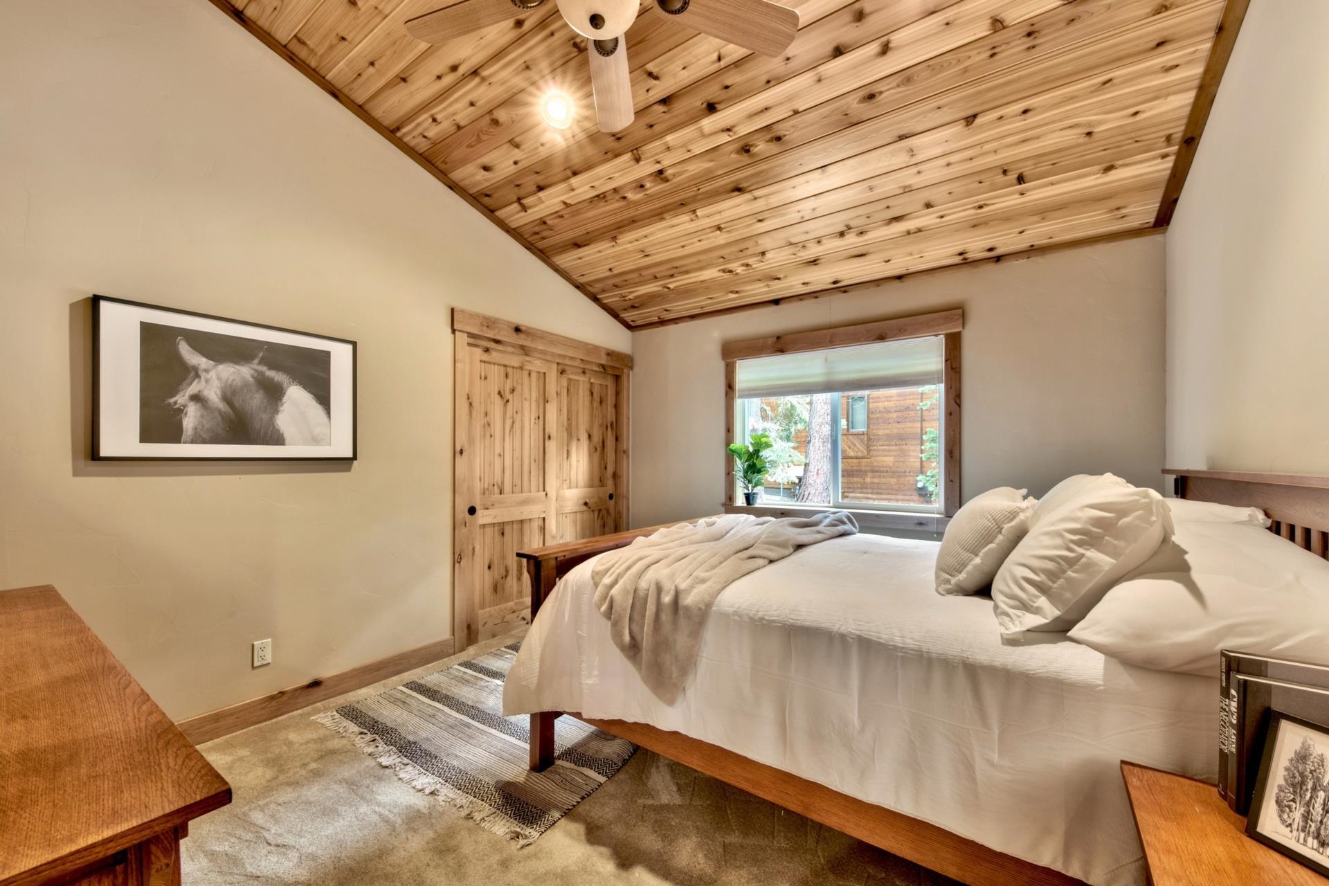 14121 Swiss Lane Truckee, CA 96161 - Photo 16 of 21 a bedroom with a bed and wooden floor