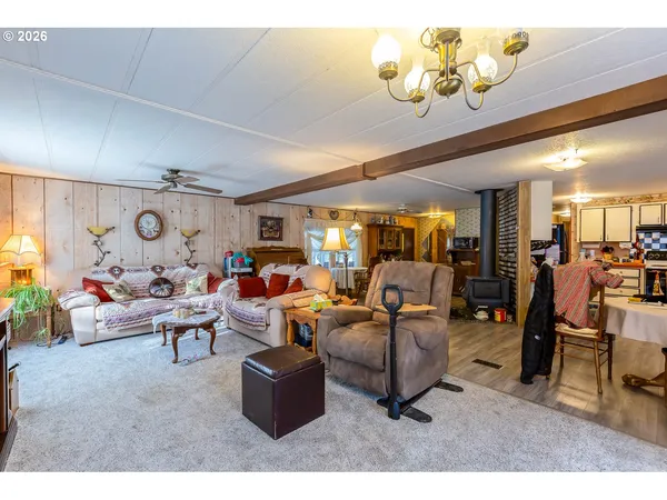 a living room with furniture a flat screen tv and a large window