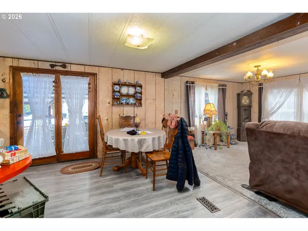 a room with lots of furniture and wooden floors