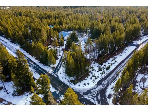 a view of a house with a yard covered in snow