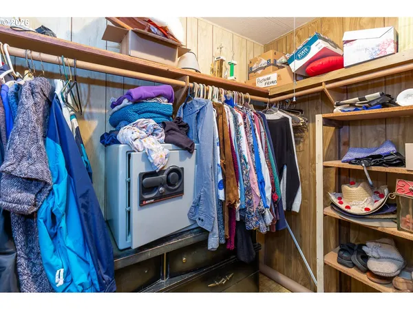 a utility room with dryer washer and a view of living room