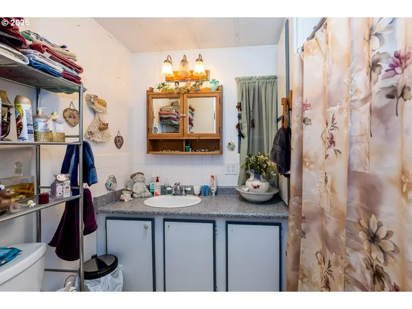 a bedroom with a bed and a bathroom
