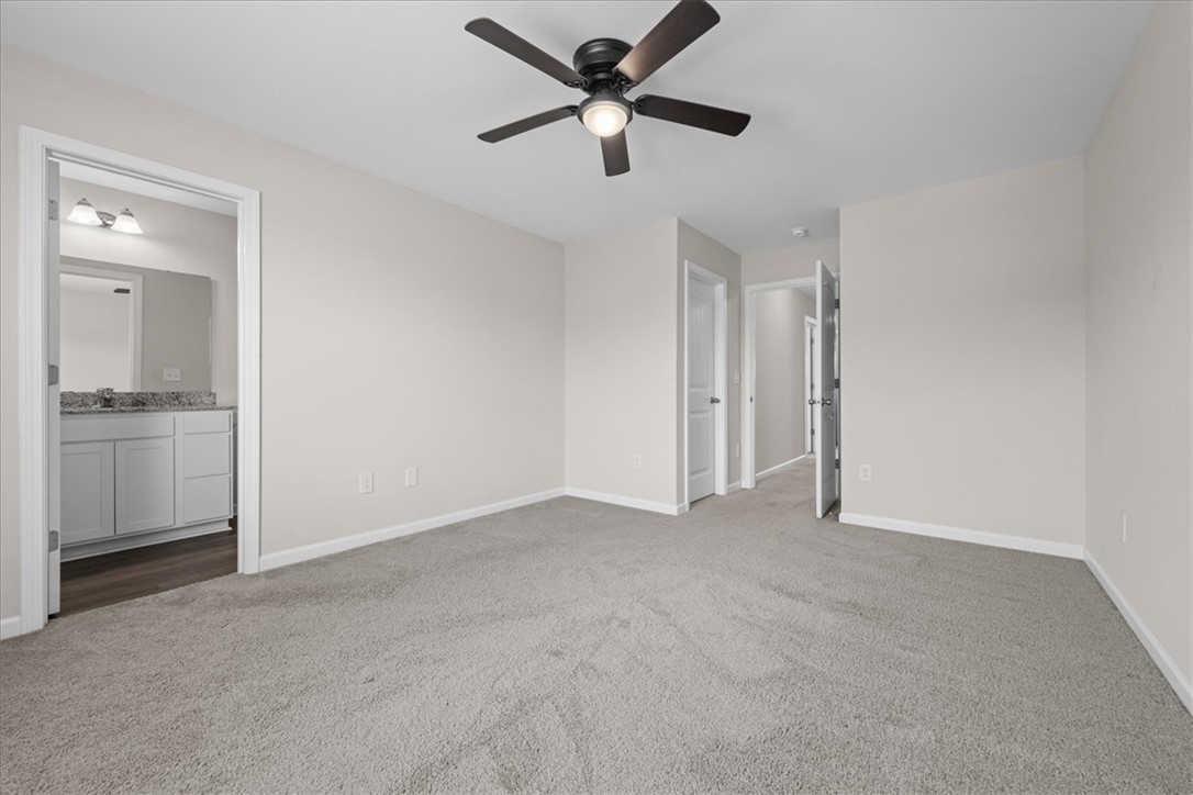 115 Adger Road Pendleton, SC 29670 - Photo 17 of 36 Well-lit sleeping quarters with plush carpeting and convenient ensuite access.