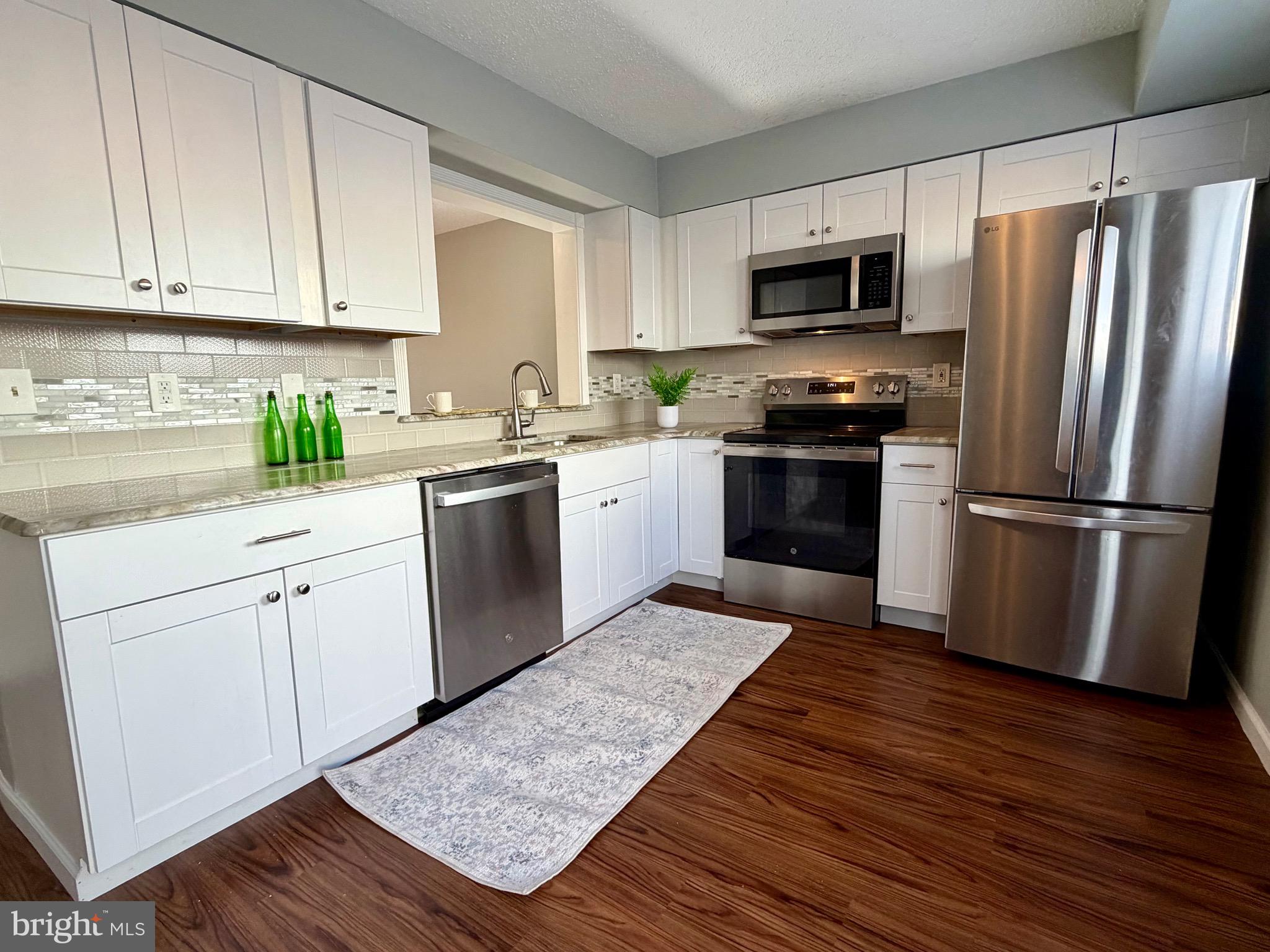 33 Georgetown Road Lindenwold, NJ 08021 - Photo 13 of 27 a kitchen with a sink stove and refrigerator