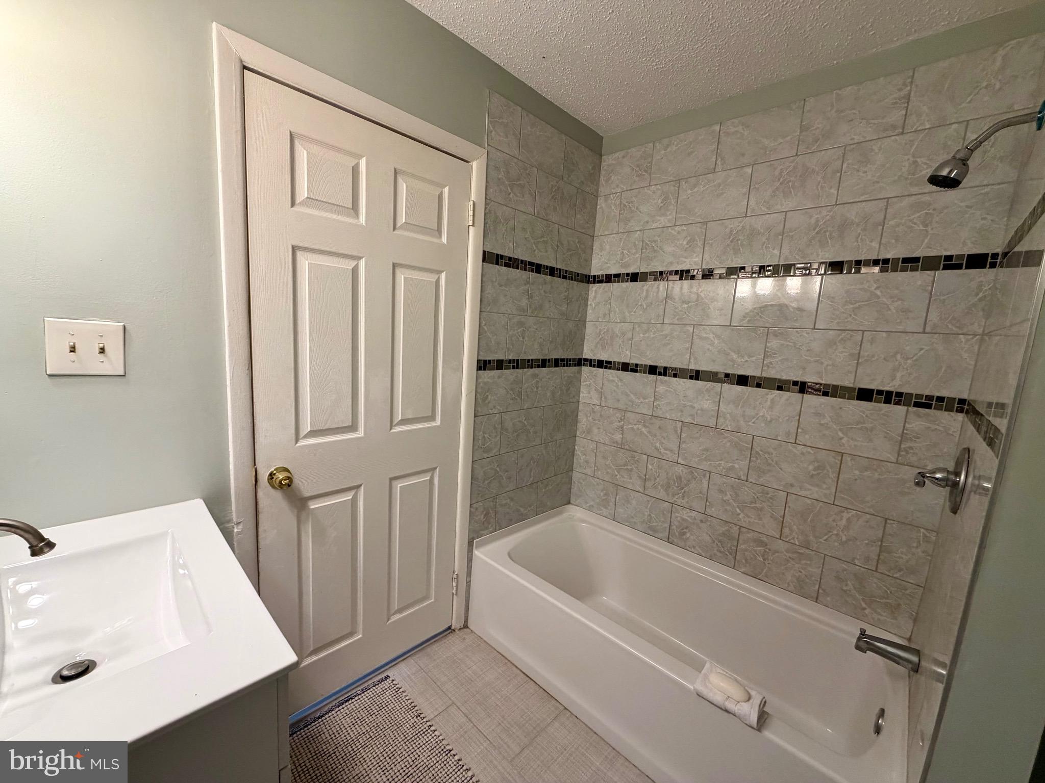 33 Georgetown Road Lindenwold, NJ 08021 - Photo 22 of 27 a bathroom with a tub a sink and a shower