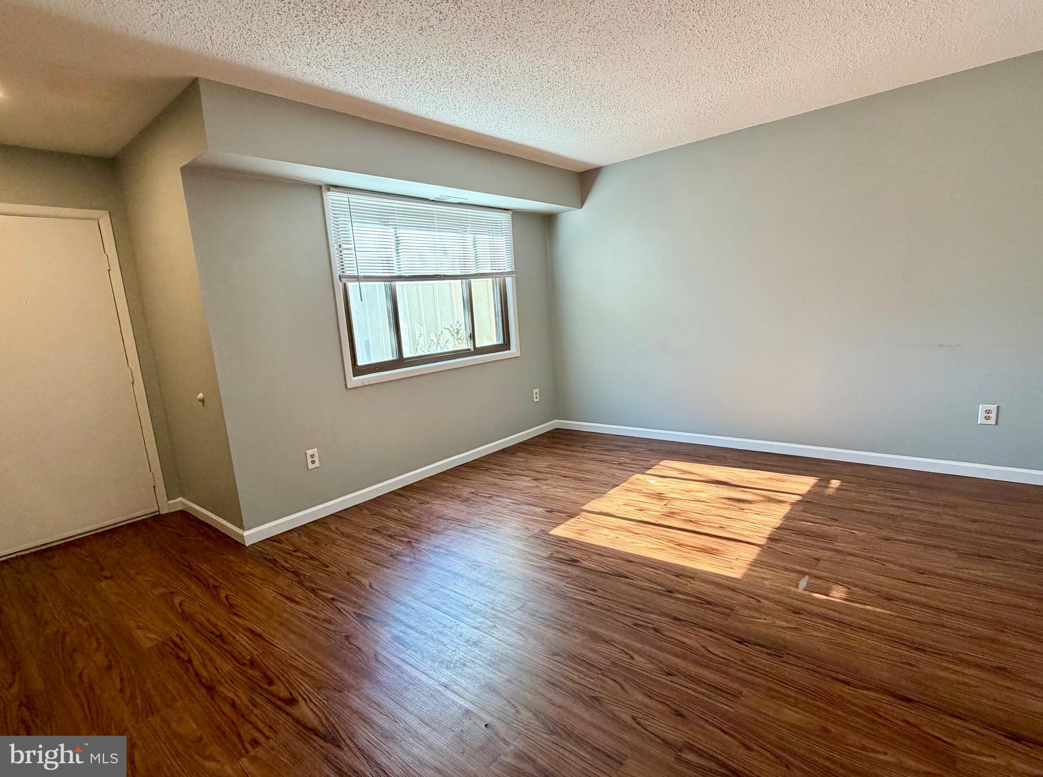 33 Georgetown Road Lindenwold, NJ 08021 - Photo 5 of 27 an empty room with wooden floor and windows
