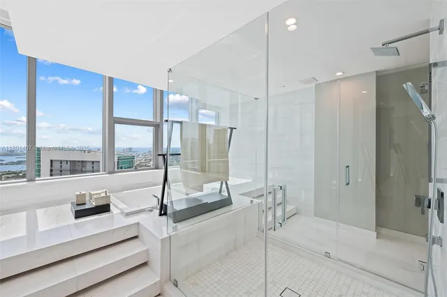 a bathroom with a toilet a sink a mirror and a window