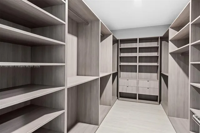 a living room with furniture large windows and wooden floor