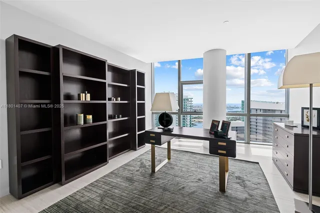 a view of a living room with furniture and a flat screen tv