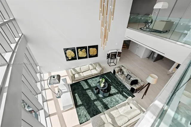 a living room with furniture and a floor to ceiling window