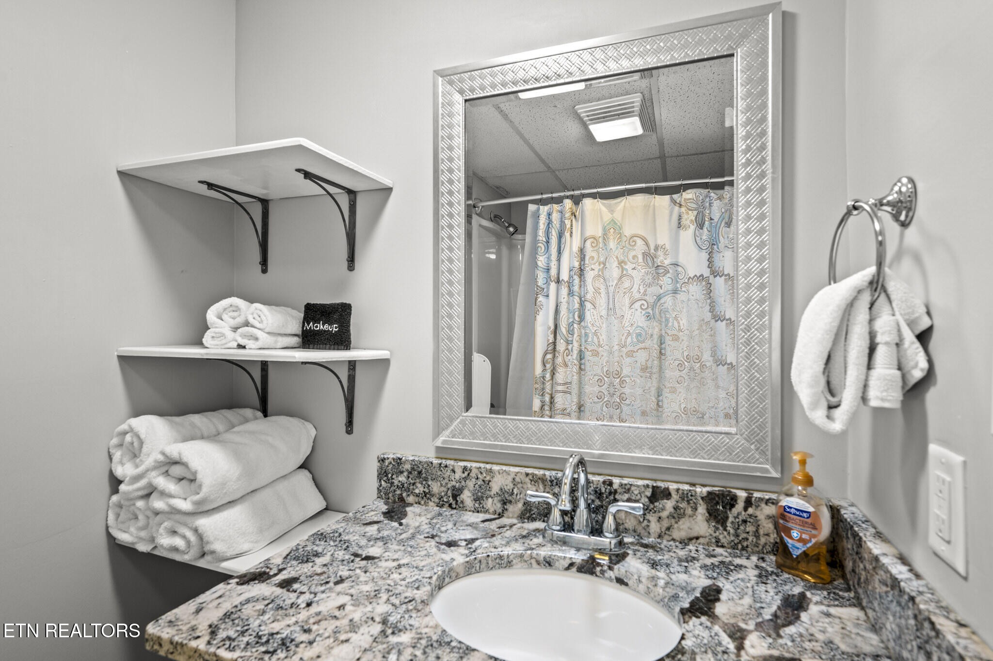 413 Baskins Creek Road, Unit 406 Gatlinburg, TN 37738 - Photo 16 of 26 a bathroom with a sink and a mirror