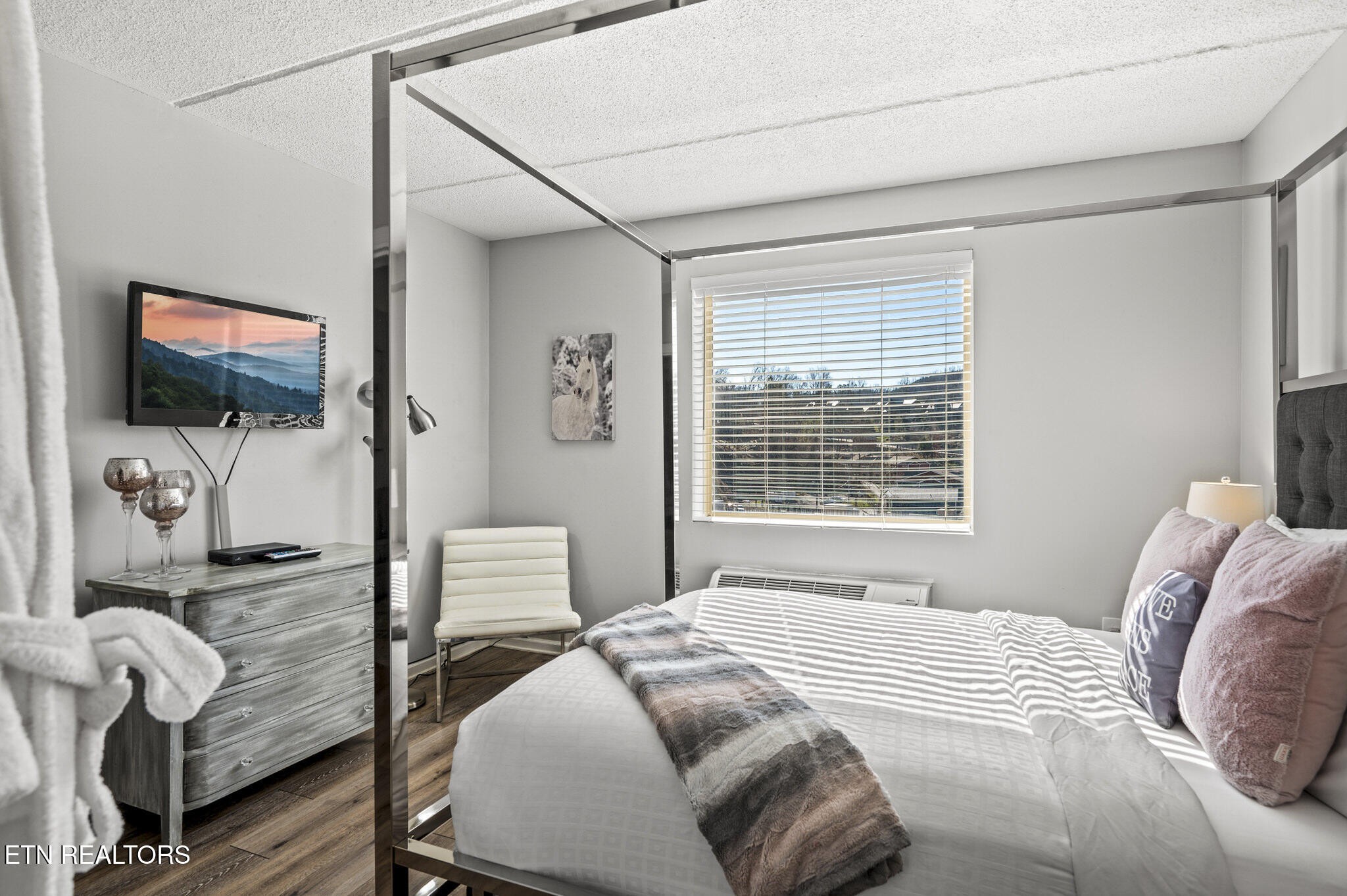 413 Baskins Creek Road, Unit 406 Gatlinburg, TN 37738 - Photo 20 of 26 a bedroom with a bed and a flat screen tv
