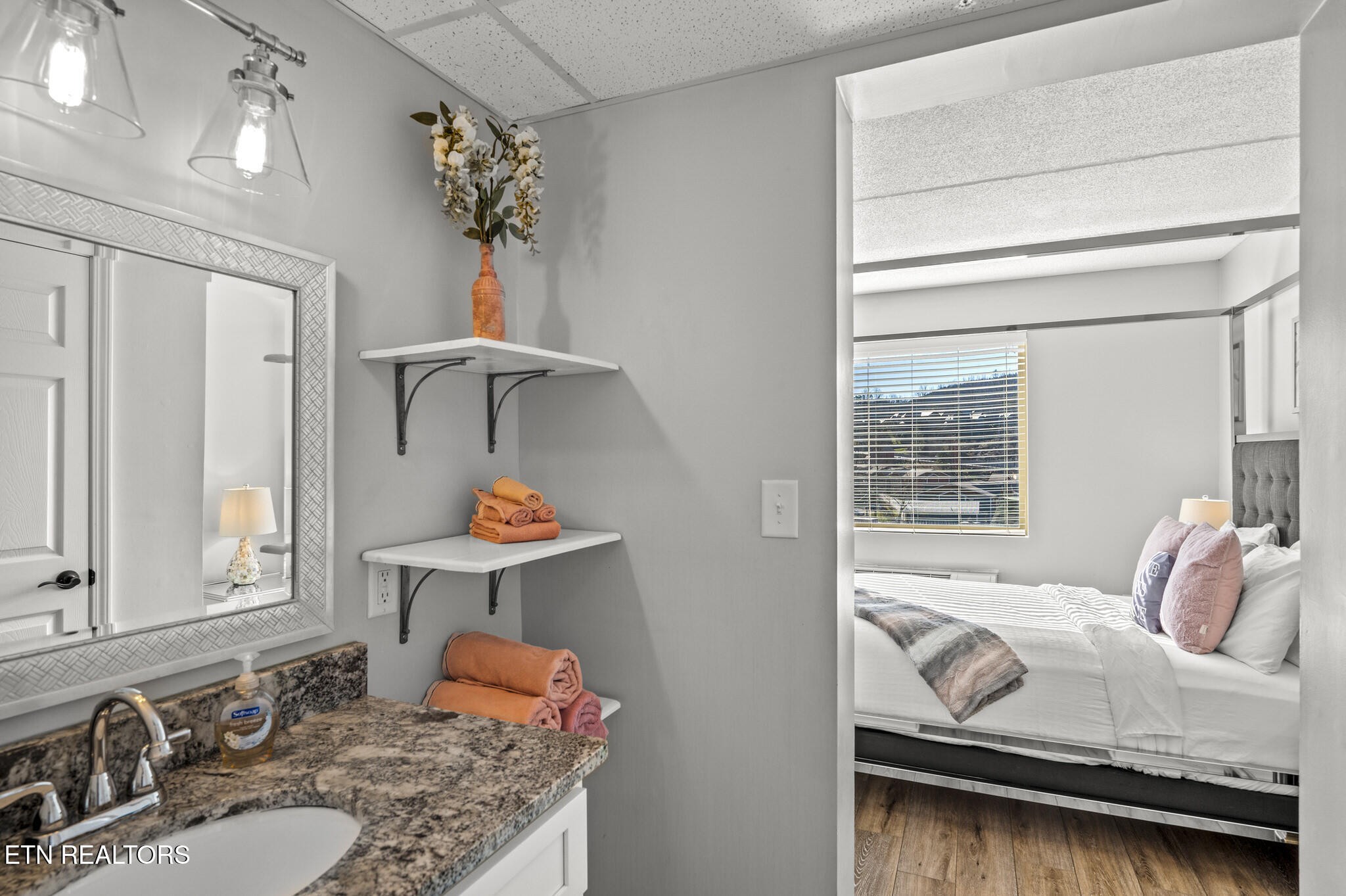 413 Baskins Creek Road, Unit 406 Gatlinburg, TN 37738 - Photo 21 of 26 a bedroom with a bed and dresser with mirror