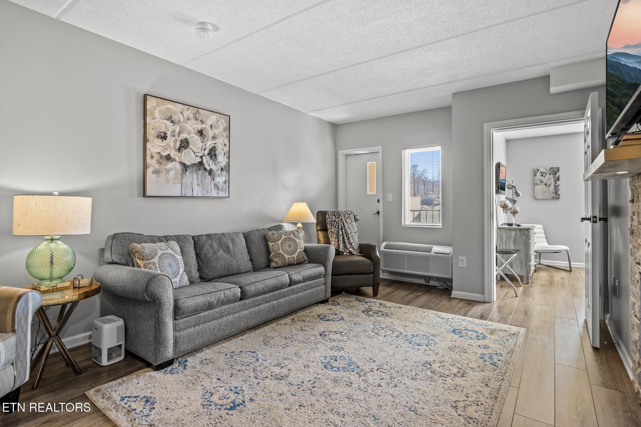 413 Baskins Creek Road, Unit 406 Gatlinburg, TN 37738 - Photo 6 of 26 a living room with furniture and a wooden floor