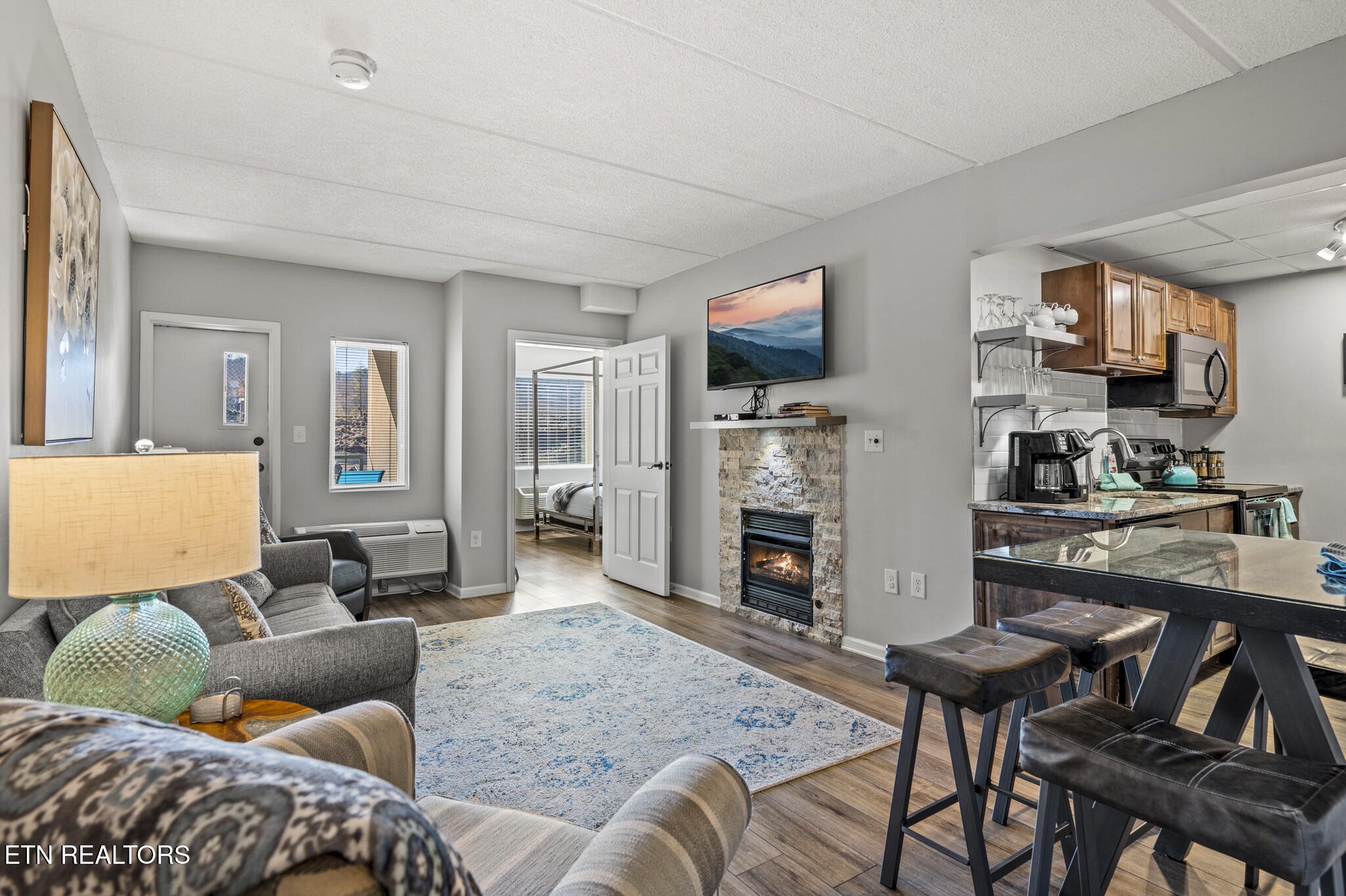 413 Baskins Creek Road, Unit 406 Gatlinburg, TN 37738 - Photo 7 of 26 a living room with furniture and a flat screen tv