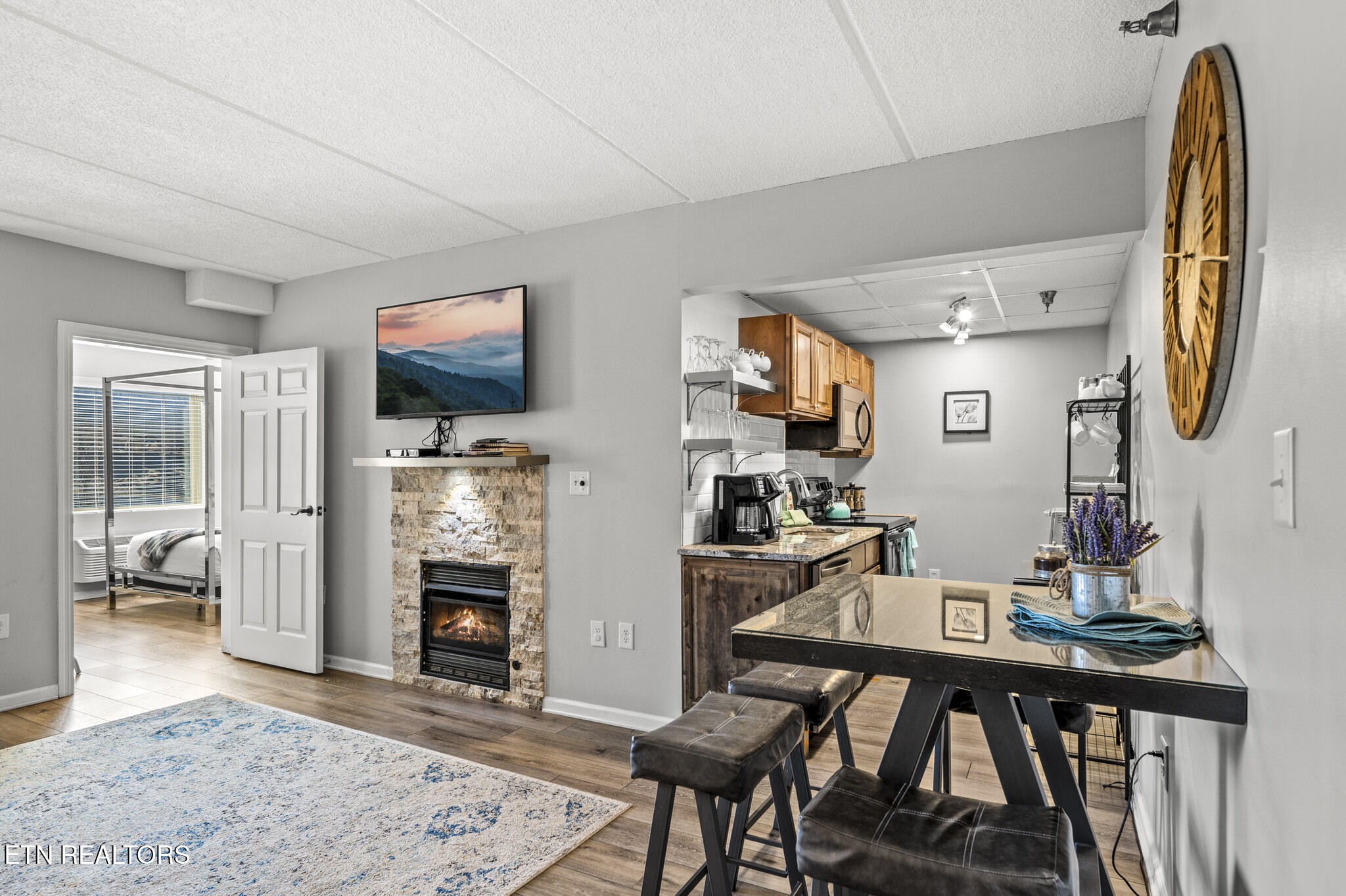 413 Baskins Creek Road, Unit 406 Gatlinburg, TN 37738 - Photo 8 of 26 a living room with furniture a flat screen tv and a fireplace