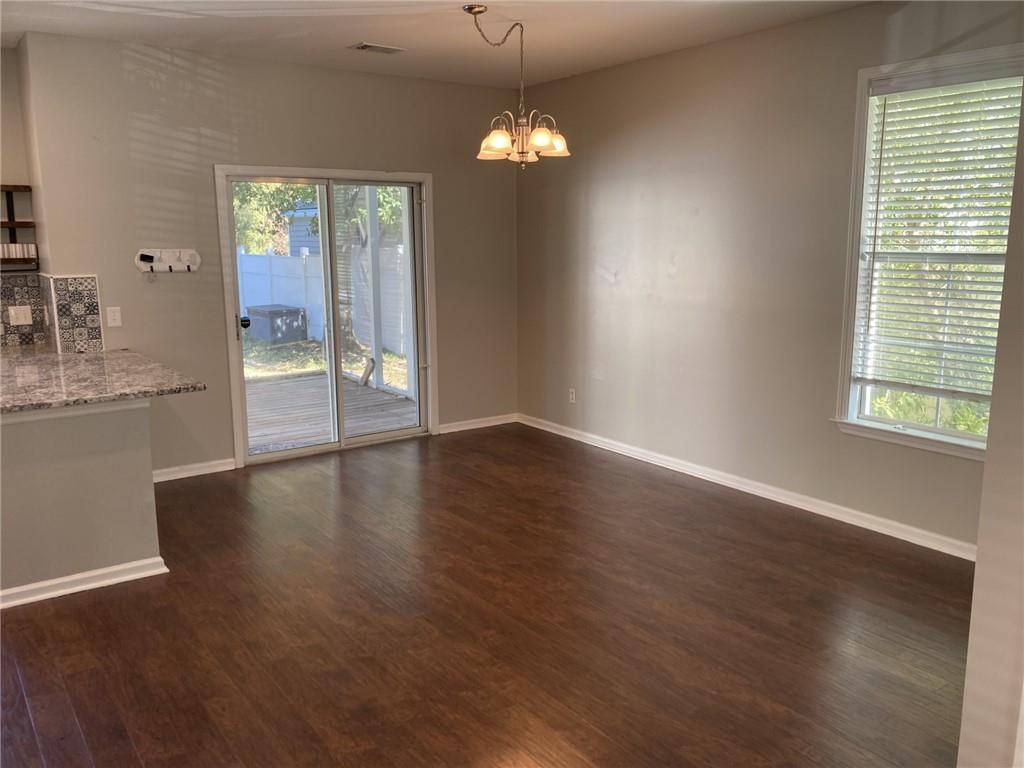 66 Godley Park Way Savannah, GA 31407 - Photo 8 of 20 an empty room with wooden floor and windows