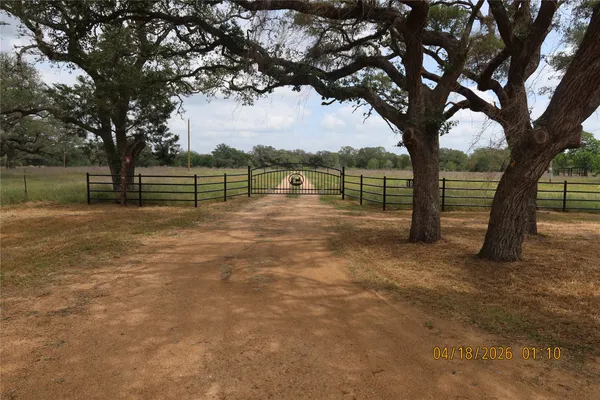 a view of a field with an trees in the background