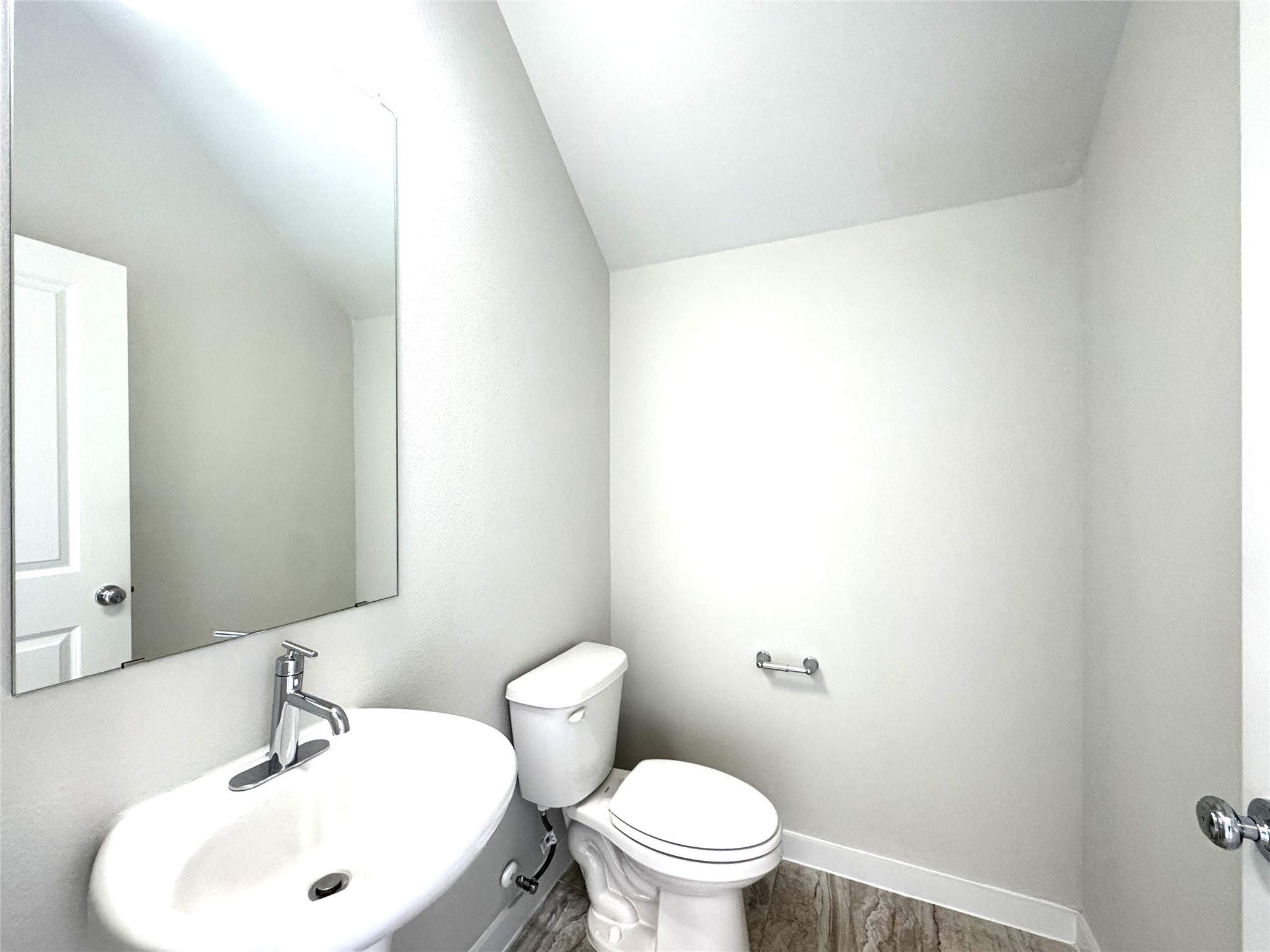 15102 Ryman Road Pflugerville, TX 78660 - Photo 5 of 12 a bathroom with a sink a toilet and mirror