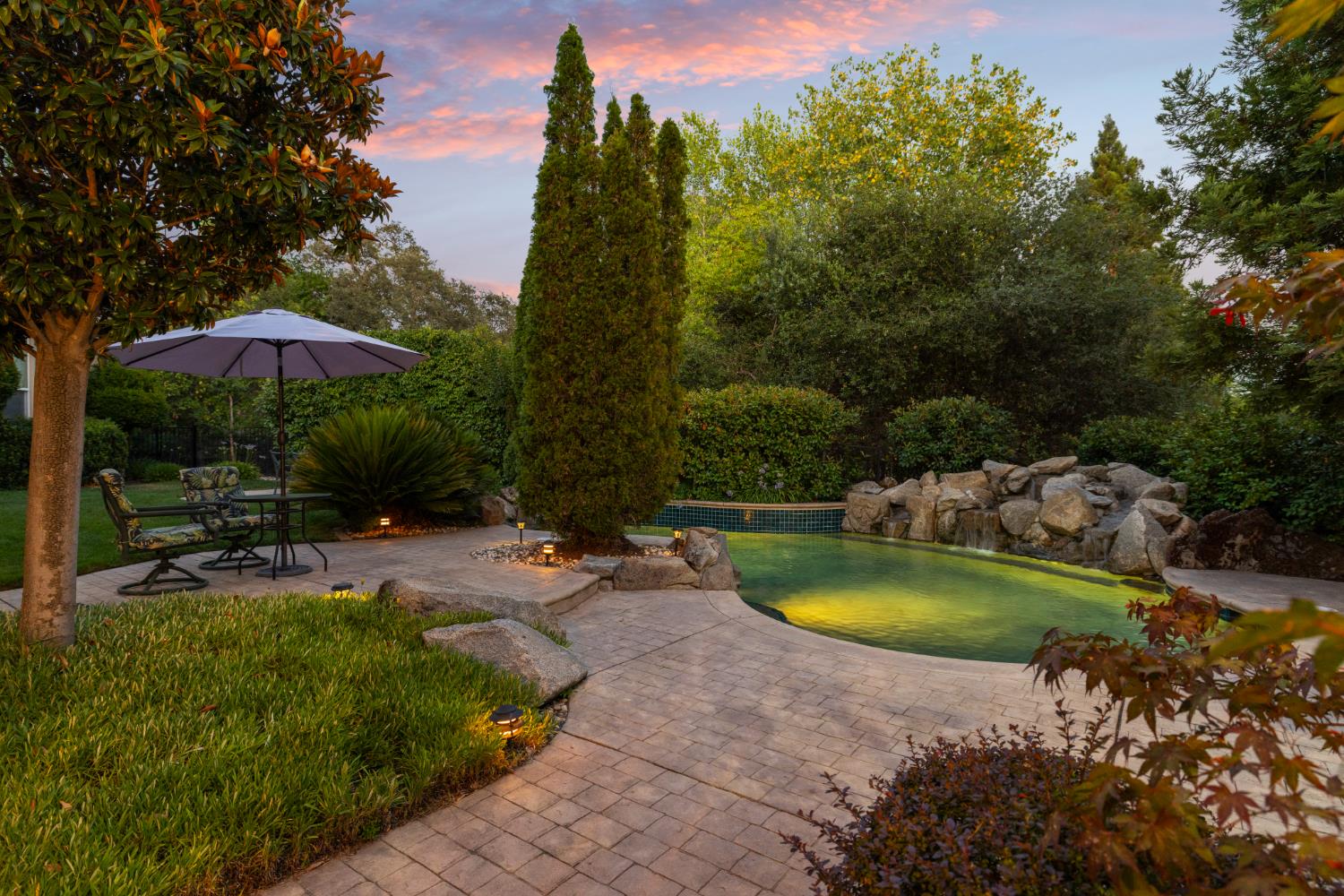 5869 Granite Hills Drive South Granite Bay, CA 95746 - Photo 48 of 66 a view of a swimming pool with lawn chairs under an umbrella