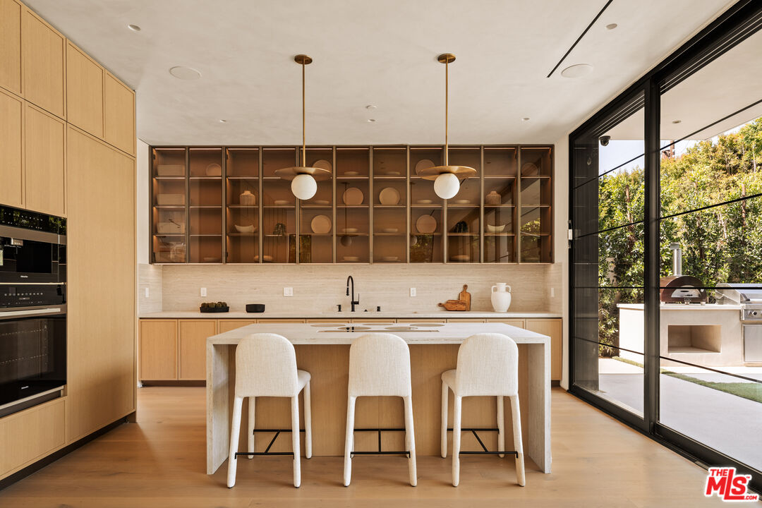 4718 Lemona Avenue Sherman Oaks, CA 91403 - Photo 15 of 40 a kitchen with a sink and chairs