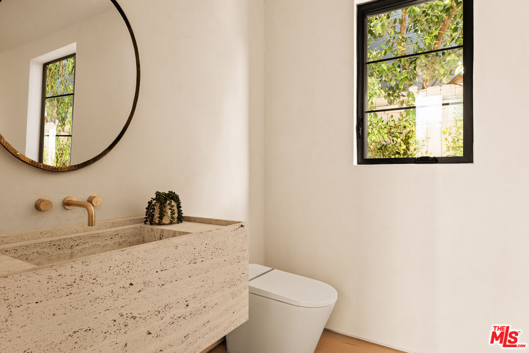 4718 Lemona Avenue Sherman Oaks, CA 91403 - Photo 18 of 40 a bathroom with a toilet sink and mirror