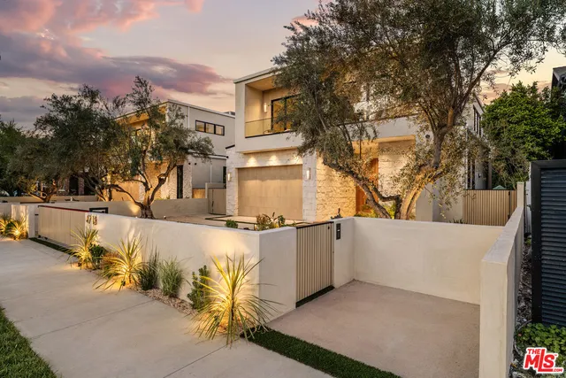 a view of a house with snow on the road