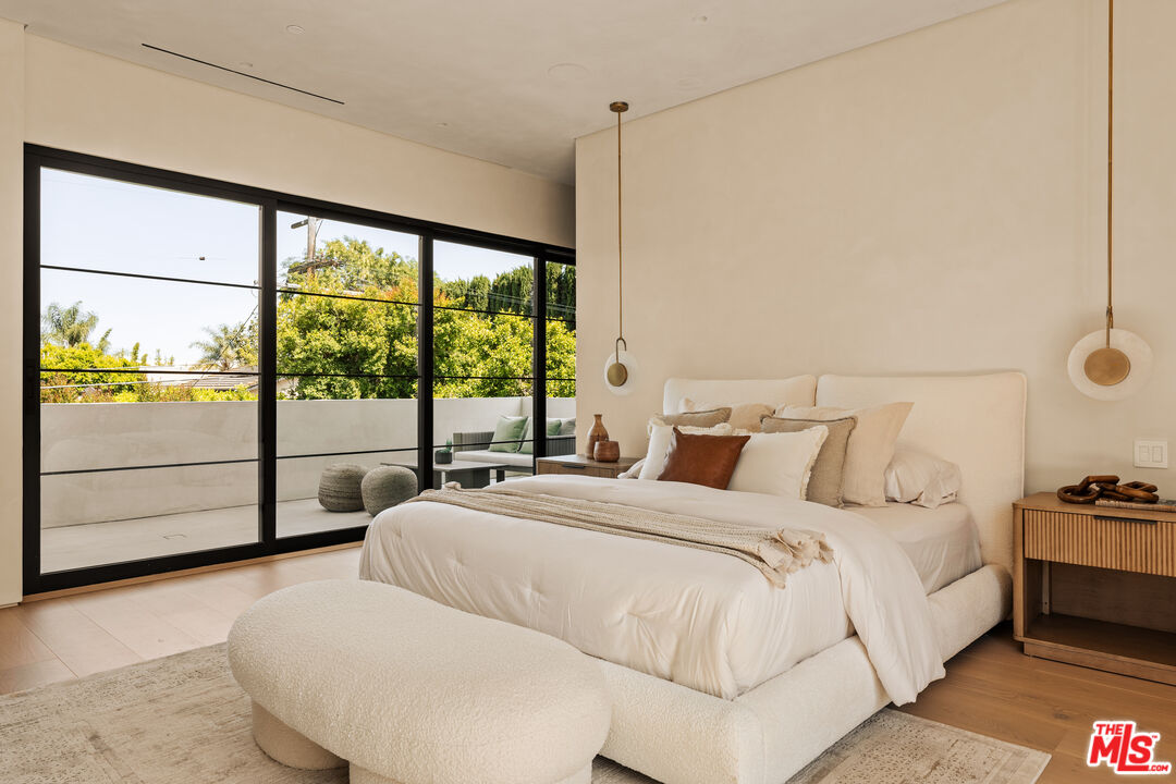 4718 Lemona Avenue Sherman Oaks, CA 91403 - Photo 23 of 40 a large white bed sitting in a bedroom next to a window