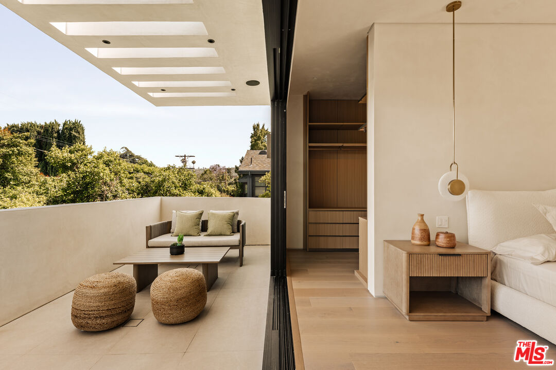 4718 Lemona Avenue Sherman Oaks, CA 91403 - Photo 25 of 40 a living room with furniture and a floor to ceiling window