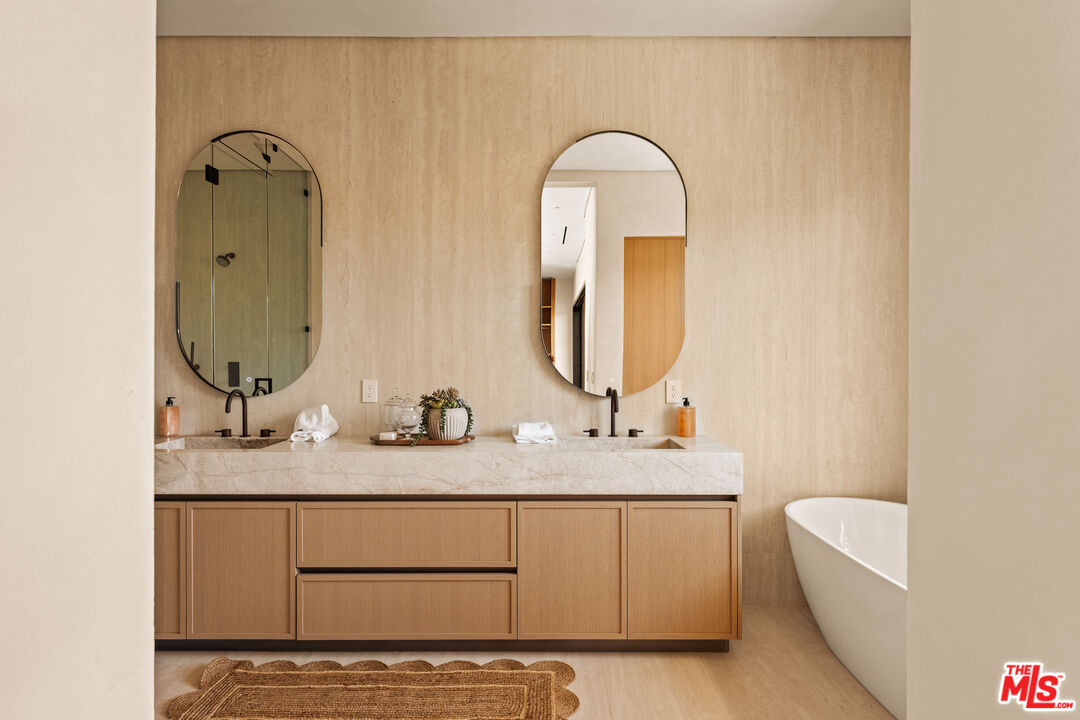 4718 Lemona Avenue Sherman Oaks, CA 91403 - Photo 28 of 40 a bathroom with a double vanity sink and a mirror