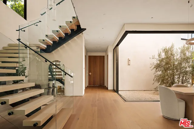 a view of entryway and hall with wooden floor