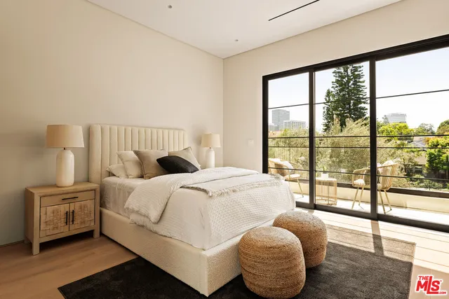 a bedroom with a large bed and a large window