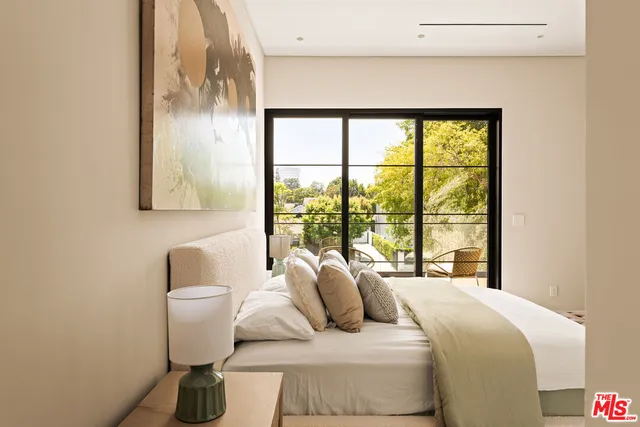 a bedroom with a bed and wall painting